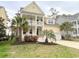 Charming two-story yellow home with double porches and a front yard with palm trees at 821 Falkirk St., Myrtle Beach, SC 29579