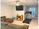 Spacious living room with a TV, cozy couch, treadmill, and outside access at 821 Falkirk St., Myrtle Beach, SC 29579