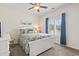 Comfortable bedroom with a ceiling fan, and a window with blue curtains at 824 Castleford Circle # 7C, Myrtle Beach, SC 29572
