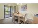 Cozy dining area featuring a table with seating for four and sliding glass doors to an outdoor space at 824 Castleford Circle # 7C, Myrtle Beach, SC 29572