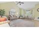 Bright living room with comfortable seating, ceiling fan, and large windows at 824 Castleford Circle # 7C, Myrtle Beach, SC 29572