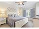 Bedroom with a large bed, side tables, lamps and a window with blue curtains at 824 Castleford Circle # 7C, Myrtle Beach, SC 29572
