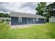 View of home's backyard, featuring a large backyard, and a blue-gray storage building at 890 Holly Sands Blvd., Little River, SC 29566