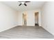 Spacious bedroom featuring modern gray flooring, ceiling fan, and ensuite bathroom and closet at 890 Holly Sands Blvd., Little River, SC 29566