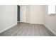 Bedroom with modern gray flooring. Doorway leads to a room with blue paint at 890 Holly Sands Blvd., Little River, SC 29566
