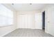 Bedroom with large closet, modern gray flooring, and natural light from large window at 890 Holly Sands Blvd., Little River, SC 29566
