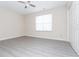 This bedroom features neutral walls, gray flooring and natural light from a window at 890 Holly Sands Blvd., Little River, SC 29566