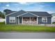 Charming single-story home with blue siding, front porch, and well-maintained lawn at 890 Holly Sands Blvd., Little River, SC 29566