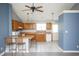 Spacious kitchen with wooden cabinetry, white appliances, and eat-in bar area at 890 Holly Sands Blvd., Little River, SC 29566