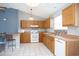 Well-lit kitchen with wooden cabinets, white appliances, and a breakfast bar at 890 Holly Sands Blvd., Little River, SC 29566