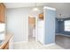 Bright kitchen with white appliances and access to the laundry room and living area at 890 Holly Sands Blvd., Little River, SC 29566