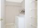 Bright laundry room featuring a washer, dryer, and ample shelving space at 890 Holly Sands Blvd., Little River, SC 29566