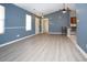Inviting living room with wood floors, ceiling fan, and a view into the kitchen area at 890 Holly Sands Blvd., Little River, SC 29566