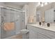 Well-lit bathroom featuring a glass shower, neutral-toned walls, and a vanity with a white countertop and cabinets at 907 Tidewater Dr., North Myrtle Beach, SC 29582
