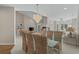 Open dining room with glass table and wicker chairs, leading to living spaces at 907 Tidewater Dr., North Myrtle Beach, SC 29582
