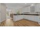 Open concept kitchen with white cabinets and a view of the dining and living spaces at 907 Tidewater Dr., North Myrtle Beach, SC 29582