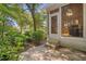 View of a rear patio with steps, surrounded by garden area, greenery and mature landscaping at 907 Tidewater Dr., North Myrtle Beach, SC 29582