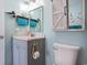 Updated bathroom vanity, mirror with decorative accents, storage, and toilet with tile flooring for easy maintenance at 9400 Shore Dr. # 716, Myrtle Beach, SC 29572