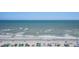 Expansive ocean view with wide sandy beach and colorful umbrellas, perfect for relaxing vacations at 9400 Shore Dr. # 716, Myrtle Beach, SC 29572