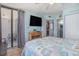 Bedroom boasts a flat screen TV, access to a balcony, and an ensuite bathroom at 9400 Shore Dr. # 716, Myrtle Beach, SC 29572