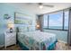 Comfortable bedroom with ocean view, lamps, and nautical decor at 9400 Shore Dr. # 716, Myrtle Beach, SC 29572