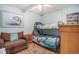 Bedroom with bunk beds, closet space, and nautical decor with a comfortable place to relax in condo at 9400 Shore Dr. # 716, Myrtle Beach, SC 29572