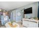 Cozy living room with TV and white stand with nautical decorations at 9400 Shore Dr. # 716, Myrtle Beach, SC 29572