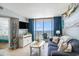Bright living room featuring ocean views, a sofa, TV, and nautical decorations at 9400 Shore Dr. # 716, Myrtle Beach, SC 29572