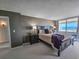 Bedroom with dark furniture and view to an outdoor patio with ocean view at 9840 Queensway Blvd. # 331, Myrtle Beach, SC 29572