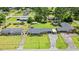 This aerial view shows the brick home's landscaping, backyard, driveway, and location in the neighborhood at 1005 S Main St., Mullins, SC 29574