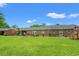 Spacious backyard featuring a large lawn and patio area, perfect for outdoor living at 1005 S Main St., Mullins, SC 29574