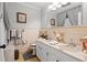 A classic bathroom boasts double sinks, framed mirror and neutral color palette at 1005 S Main St., Mullins, SC 29574