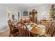 Dining room featuring wood table and chairs, with a decorative curio cabinet at 1005 S Main St., Mullins, SC 29574