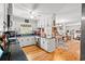 Bright eat-in kitchen features granite countertops, wooden floors, and white cabinets and is adjacent to a dining area at 1005 S Main St., Mullins, SC 29574