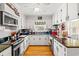Cozy kitchen featuring white cabinets, granite countertops, and stainless-steel appliances, perfect for cooking and gathering at 1005 S Main St., Mullins, SC 29574