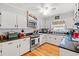 Classic kitchen featuring white cabinetry, wood floors, granite counters, and stainless-steel appliances with ample counter space at 1005 S Main St., Mullins, SC 29574