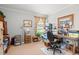A home office is filled with natural light, ample storage, and a functional workspace at 1005 S Main St., Mullins, SC 29574