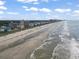 Expansive beach view showcasing coastline condos and a wide sandy shore, perfect for coastal living and recreation at 1011 S Ocean Blvd. # 301, North Myrtle Beach, SC 29582