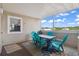 Enclosed outdoor balcony with four chairs and a table to enjoy the weather at 1011 S Ocean Blvd. # 301, North Myrtle Beach, SC 29582