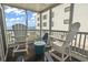 Screened balcony offering stunning ocean views and comfortable seating with white Adirondack chairs at 1011 S Ocean Blvd. # 301, North Myrtle Beach, SC 29582