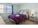 Cozy bedroom with a comfortable bed, large window providing natural light, and stylish nautical-themed decor at 1011 S Ocean Blvd. # 301, North Myrtle Beach, SC 29582