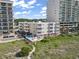 Coastal condo with a pool, deck, and beach access nestled between two larger condo buildings at 1011 S Ocean Blvd. # 301, North Myrtle Beach, SC 29582