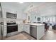 Bright kitchen features stainless appliances, ample white cabinets, and an open design to the living area at 1011 S Ocean Blvd. # 301, North Myrtle Beach, SC 29582