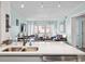 Open concept kitchen includes sleek countertops and sink, connecting seamlessly to the well-lit living room and balcony at 1011 S Ocean Blvd. # 301, North Myrtle Beach, SC 29582