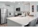 Bright kitchen featuring white cabinetry, stainless appliances, and a cozy breakfast bar at 1011 S Ocean Blvd. # 301, North Myrtle Beach, SC 29582