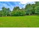 This is a view of a large manicured lawn with mature trees at 1025 Penny Ln. # 1025, Myrtle Beach, SC 29577