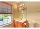 Bright bathroom featuring a large window, vanity with a mirror, and a toilet at 1025 Penny Ln. # 1025, Myrtle Beach, SC 29577
