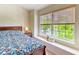 Sunlit bedroom featuring a bed, a large window with a window seat, and neutral colors at 1025 Penny Ln. # 1025, Myrtle Beach, SC 29577
