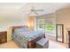 Bright bedroom featuring a floral patterned bedspread, a ceiling fan, and natural light from the window at 1025 Penny Ln. # 1025, Myrtle Beach, SC 29577