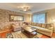 Comfortable living room featuring a brick wall, plush sofas, and natural light at 1025 Penny Ln. # 1025, Myrtle Beach, SC 29577